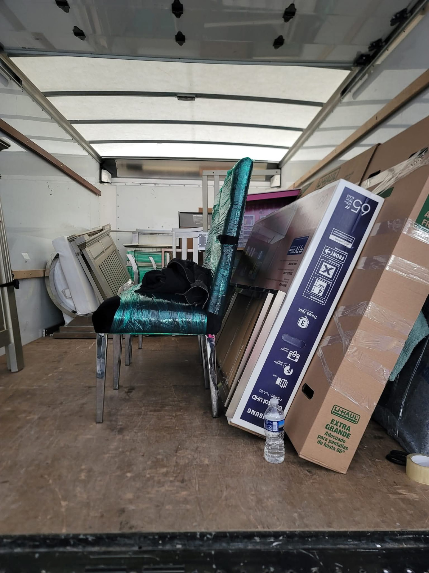 Furniture shrink-wrapped and stacked inside a Major Movers truck