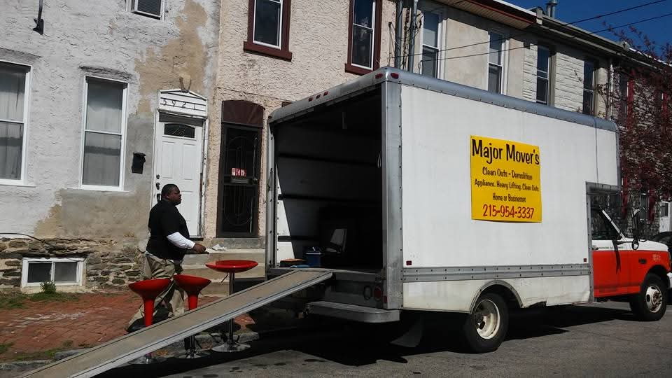 Major Movers crew loading furniture outside a Philly rowhome